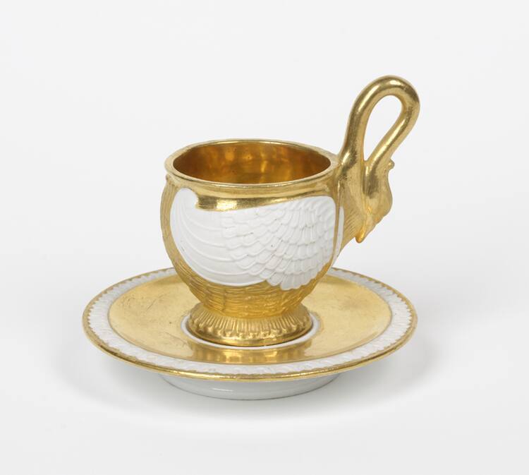 One of a set of four gilt and white bisque swan-form demitasse cups and saucers.