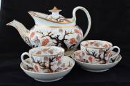 A teapot with a stand from a twenty-one-piece tea service characterized by a tree and its base …