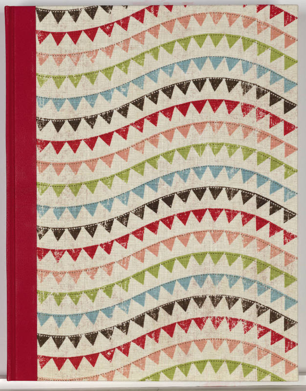 The front cover features a solid red fabric spine and colorful alternating bunting.