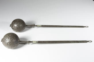 One of a pair of rice steamers or fryers in the form of a pierced tin ball with a hinge to open…