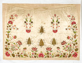 A silk apron embroidered with red flowers and spade-shaped leaves.