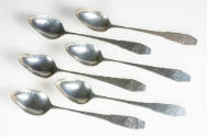 The set of six silver teaspoons with monogrammed coffin handles. 