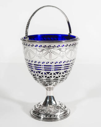 Sterling silver sugar basket with cobalt blue glass liner. The handle and base have an openwork…