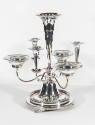 An eight-piece Victorian silver-plate epergne with a flower-shaped vase center support and mirr…