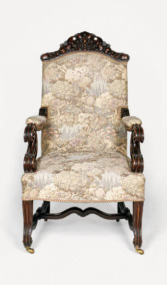 One of a pair of carved oak, stuffed armchairs in a Rococo Revival style, including carved cres…