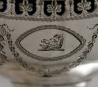 A detail of the boar's head crest on the side of the basket.