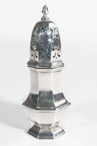 An English sugar caster with a removable pierced top over a paneled baluster body. 
