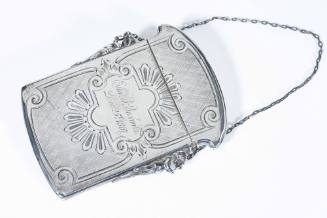 This silver purse with a chain handle was used to carry calling cards.