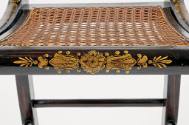 A detail of the front stretcher bar with a floral design.