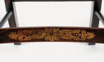 A detail of the lower front stretcher bar gilded with a floral design.