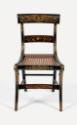 One of six klismos, cane-seated chairs from a suite of high-style, ebonized and rosewood-graine…