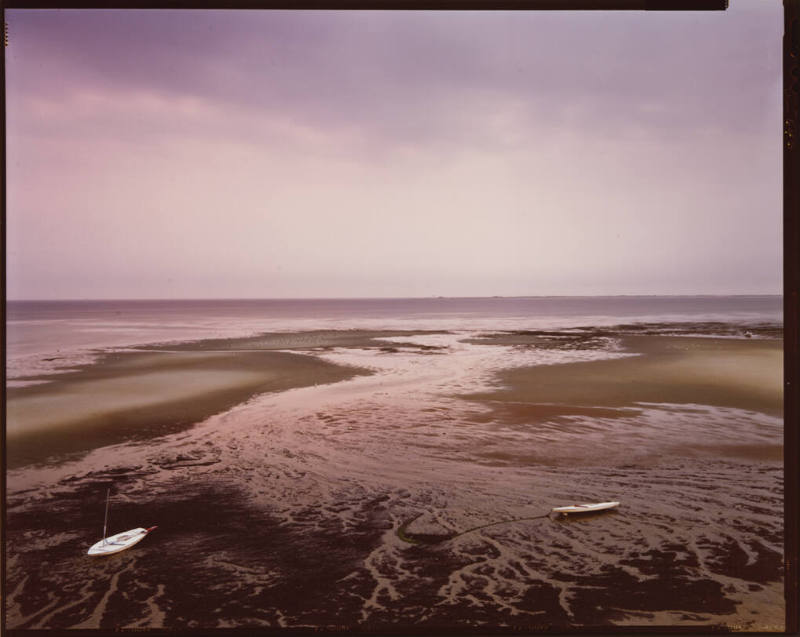 A color photograph showing a pink-toned ocean landscape on Cape Cod.