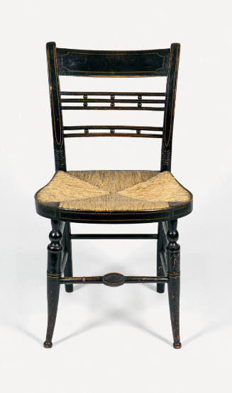 One of four Sheraton-style fancy painted black and gilt side chairs with rush seats.