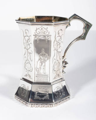 An octagonal paneled, gilded silver presentation cup with a skirted base and angular gothic sty…