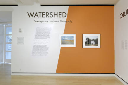 Installation shot of the entrance and title wall for the exhibition Watershed: Contemporary Lan…