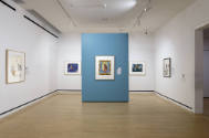 An installation shot of the accent wall and remaining prints on the opposite side of the galler…