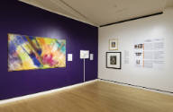 An installation shot of the southwest corner of the Levitt gallery with the deep purple accent …