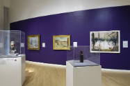 An installation shot of the deep purple accent wall continuing from the front Levitt gallery in…