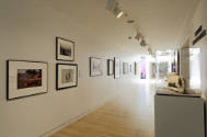 An installation shot of the west wall of the second-floor corridor installed with a series of t…