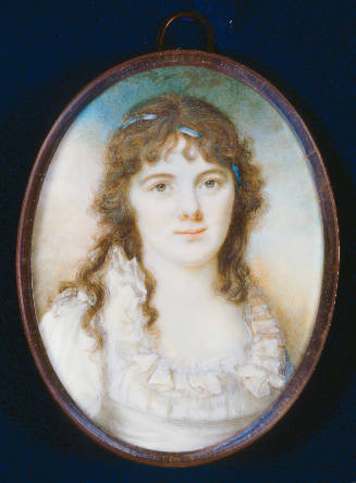 A woman with curly brown hair with a light blue ribbon and wearing a white dress with ruffle al…