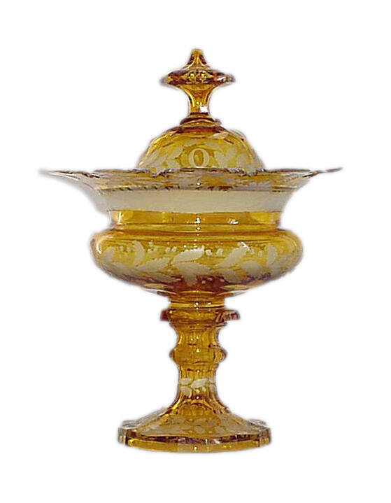 A lidded amber-flashed and etched lead crystal compote with foliate designs and scenes depictin…