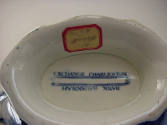 A detail of the bottom of the sauce tureen inscription titling the images: "EXCHANGE CHARLESTON…