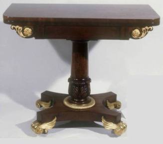 A lift-lid card table with leather inset top, acanthus carved stem, and brass scroll feet.