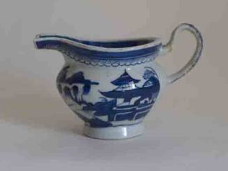 One of a pair of porcelain cream pitchers from a set of dinnerware featuring blue and white Chi…