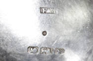 A detailed image of the maker's mark and hallmarks impressed in the bottom center of the pitche…