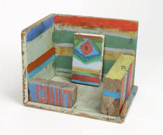A multi-colored, striped wooden assemblage of a studio equipped with a stretched canvas paintin…