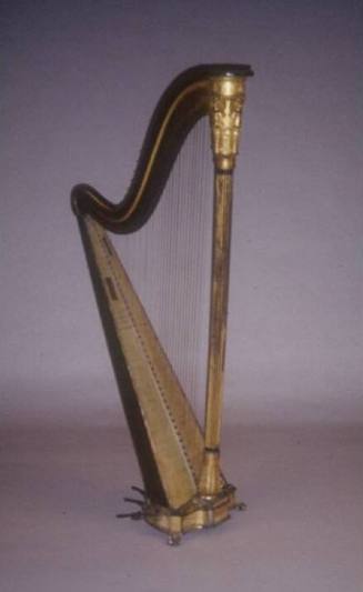 A gilded harp with reeded central column, neoclassical angels and cherubs beneath the crown, an…