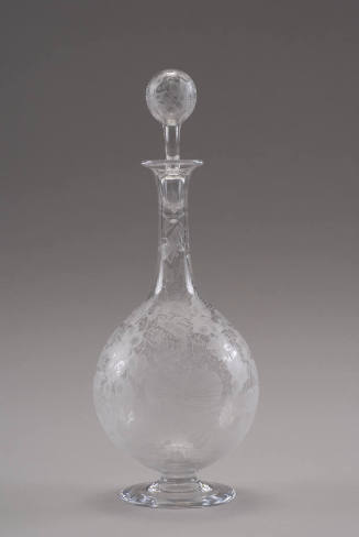 A blown clear glass footed decanter with a stopper, etched with hummingbirds and morning glory …