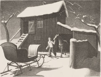 A man leading a horse in the snow out of a barn to a nearby sleigh. 