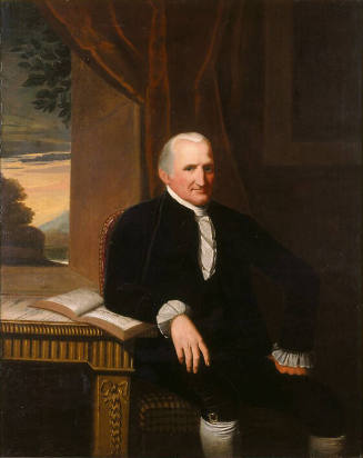 Three-quarter length portrait of a man seated in a chair with his proper left hand on his thigh…