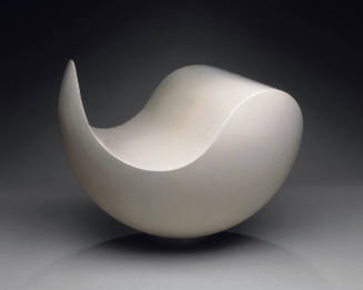 A white rounded sculpture with an S-shaped curve.