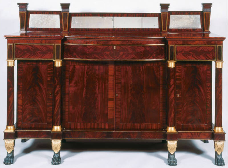 A Duncan Phyfe-style sideboard of flame grained mahogany with mirrored splashboard above a cont…