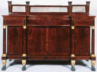 A Duncan Phyfe-style sideboard of flame grained mahogany with mirrored splashboard above a cont…