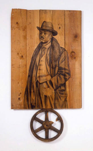 A drawing of a man in a suit on weathered wood with an attached wooden wheel on the bottom.
