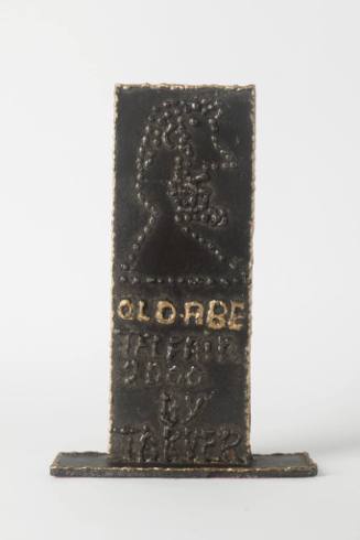 A flat, upright metal plate with a dotted relief of President Abraham Lincoln's profile. 