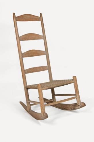 An oak ladder-back rocking chair with a low, woven split oak seat over four stretchers and four…