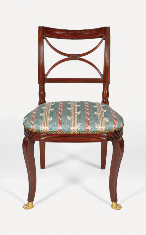 A mahogany side chair from a set of seven, each with a scroll back crest panel with carved thun…