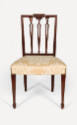 One of a pair of Sheraton-style side chairs with square backs, carved urn splats topped with fo…