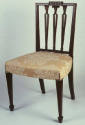 One of a pair of Sheraton-style side chairs with square backs, carved urn splats topped with fo…