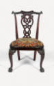 A chair with a decorative open back, upholstered seat and claw and ball feet on cabriole front …