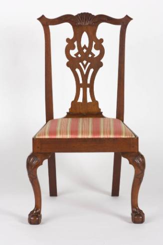 An American mahogany Chippendale-style chair with a curlicue back splat, heavily-carved crest s…