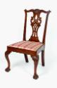 An American mahogany Chippendale-style chair with a curlicue back splat, heavily-carved crest s…