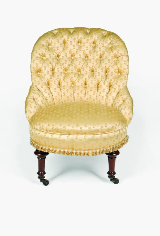 A Victorian armchair upholstered in gold brocade with a tufted back from three-piece suite comp…