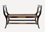 One of a pair of window benches from a suite of high-style, ebonized and rosewood-grained mahog…