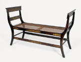 One of a pair of window benches from a suite of high-style, ebonized and rosewood-grained mahog…