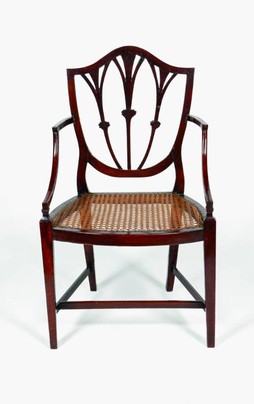 A Hepplewhite-style shield back mahogany armchair with a cane seat.